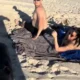 Moment 9-month pregnant woman catches her husband with side chic on the beach