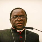 Kukah has changed politically, owes Buhari apology – Fr Kelvin