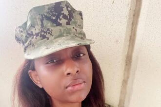 Actress, Grace Charis Bassey disassembling, cleaning her rifle after joining US military