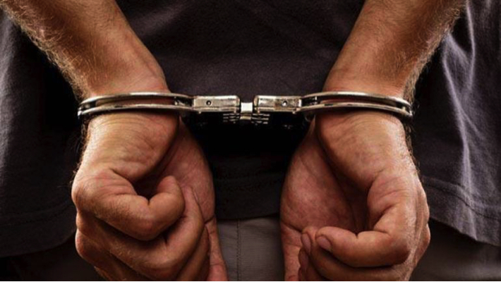 Man in handcuffs used to illustrate the story